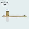 Modern polished brass cabinet knob with textured knurled design and gold accent

