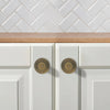 Modern brass cabinet knobs with a curved handle, adding a touch of sophistication.
