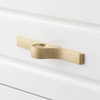 Modern brass cabinet knobs with a curved handle, adding a touch of sophistication.
