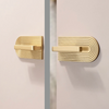 Modern brass cabinet knobs with a curved handle, adding a touch of sophistication.
8