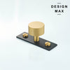 Striped design matte brass knob mounted on black rectangular plate

