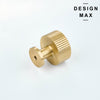 Matte black bathroom vanity with contrasting brass knobs for luxe appeal
