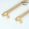 Two matte brass appliance pulls with a textured, possibly knurled, cylindrical grip, one long and one short, angled on a white background